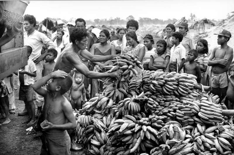 Miskito Indians from Nicaragua wait for a food distribution at a Honduran camp during the 1980s.
