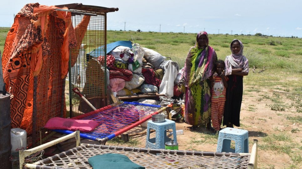 A Sudanese family displaced by the floods in Alganaa camp  with the belongings they salvaged.