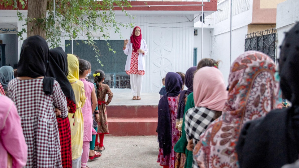 Addressing an assembly at her former school, Saleema encourages the young refugee girls to keep studying and following their dreams. 