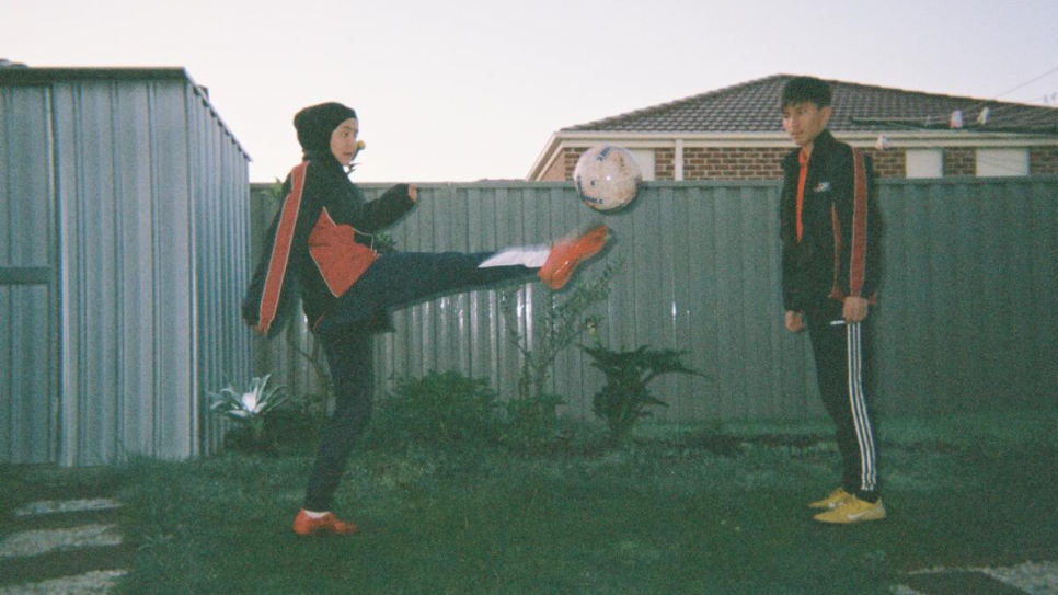 Young refugees from the Melbourne Victory FC football programme kick a ball in Melbourne, Victoria, Australia. 