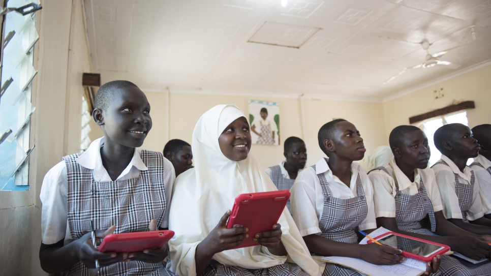 Mary and Mumina use tablets in Class 8 at Angelina Jolie School,  a UNHCR-supported girls' boarding school in northwestern Kenya's Kakuma Refugee Camp. The school was connected to the Internet in 2016 with help from the Vodafone Foundation. Through the Vodafone Foundation's Instant Network Schools initiative, selected schools and community centres receive computer tablets, solar-powered batteries, a satellite or mobile network, and a suite of software and online learning material. Each Instant Network School (INS) has a local coach who provides both training and support for students and teachers. ; There are currently more than 30 INS in four countries. In Kakuma Refugee Camp, approximately 30,000 students and community members benefited from the initiative in the first half of 2019.