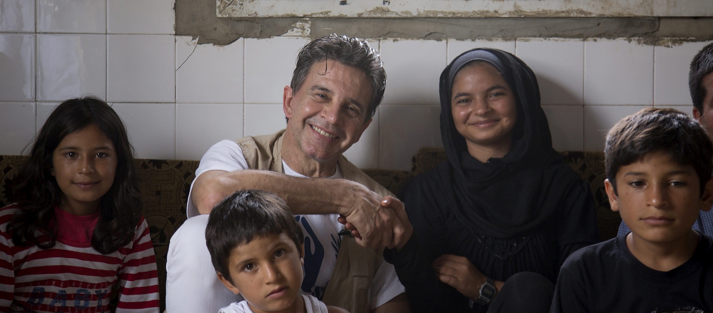 Lebanon / GWA visit / Uruguayan-Argentinian actor and UNHCR Goodwill Ambassador Osvaldo Laport, centre, shakes the hand of Marwa during a visit at their house in Zgharta on August 28, 2014. Laport is on a four-day long visit in Lebanon in conjunction with a delegation from Uruguay, who are working with UNHCR to resettle Syrian refugees. / UNHCR / D. Khamissy / August 2014