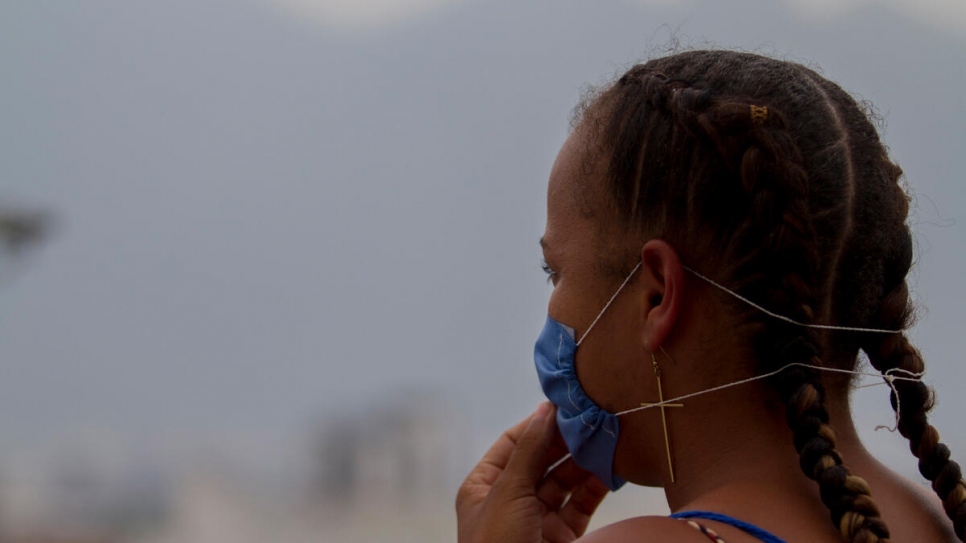 Rosario Johnson looks out over the city of Monterrey, Mexico. She moved to the city days earlier with the help of a UNHCR refugee integration programme.