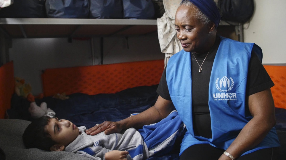 Hendricks pictured with Aala, an 8-year-old Syrian boy with severe disabilities, who she met with his family in 2016 at a camp near Thessaloniki in northern Greece.