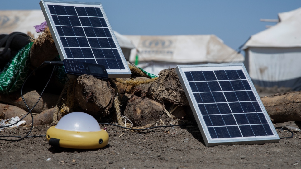 Solar panels charge outside a shelter in Tunaydbah refugee settlement in eastern Sudan.  