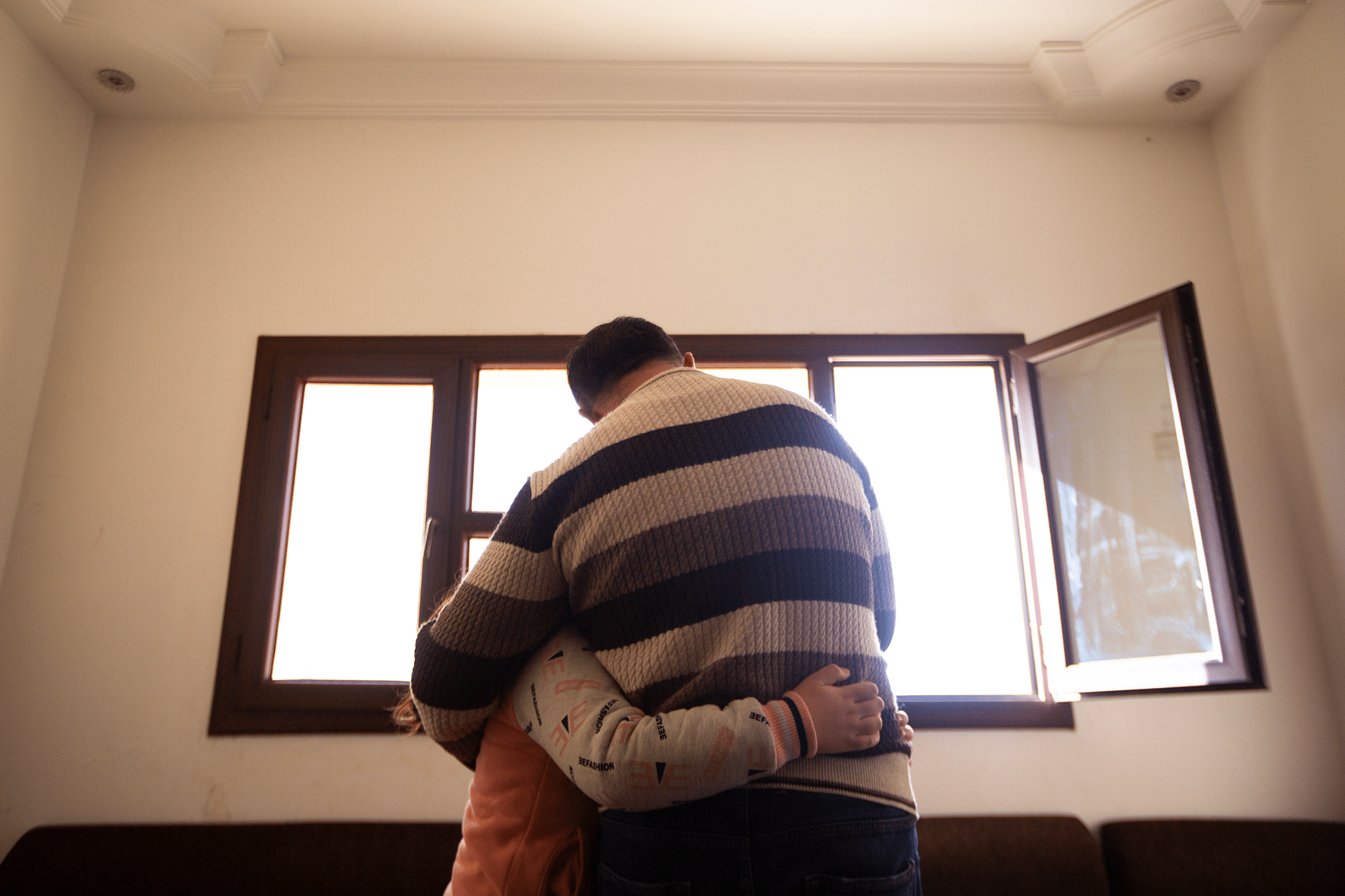 Young Syrian refugee with her father.