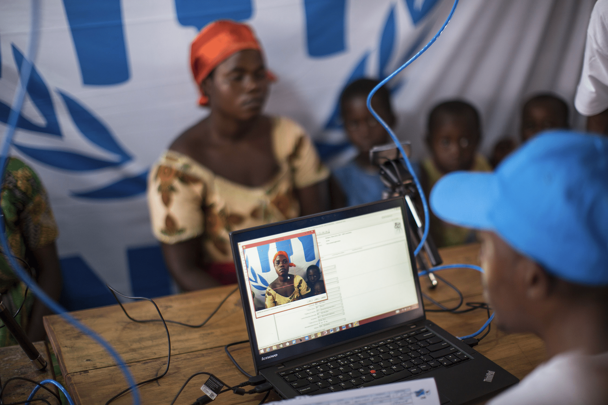 Refugee Aline poses for her photo during UNHCR’s registration process.