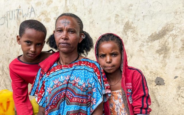 woman and children looking at camera