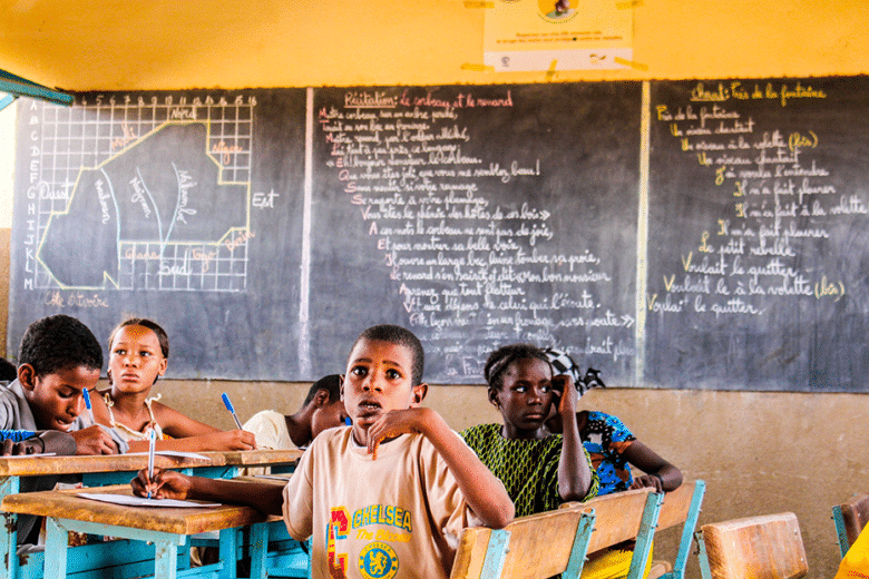 Malian refugee children study at an UNHCR-supported primary school in one of the refugee camps in Burkina Faso.