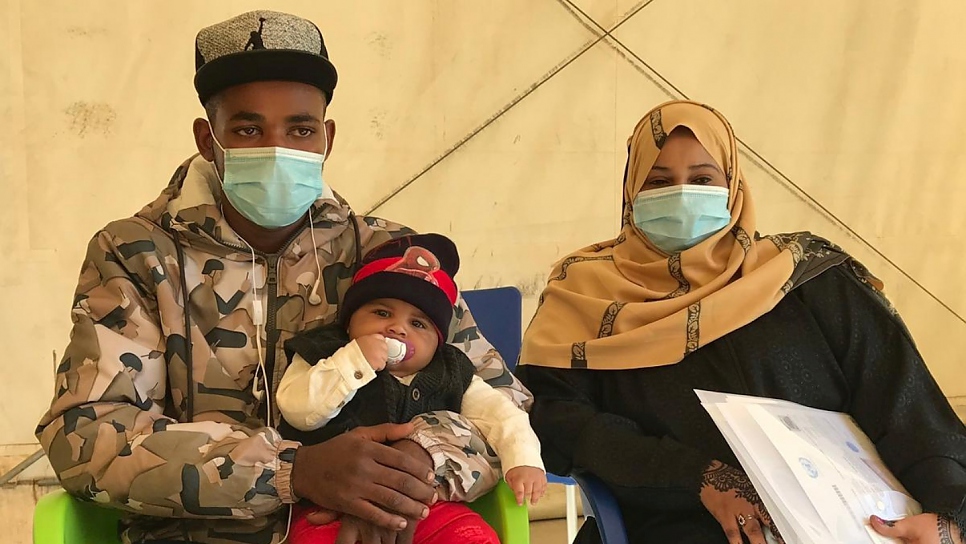 Somali asylum seekers Fawaz 21, Adnan, four  months, and Farah, 24, prepare to take the humanitarian evacuation flight from Libya to Rwanda.

