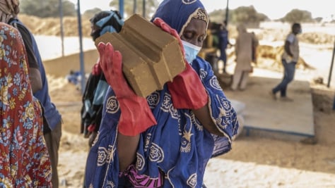 Construction workers representing both the refugee and local communities build the first of 1,000 brick homes to be built in Ouallam village in Niger.