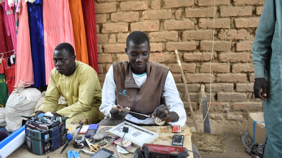 Issa learned to repair phones for other refugees and locals after practicing on his own mobile.