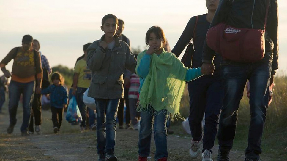 Refugees arriving at the 'collection point' at the end of the day, coming from the Serbia. ; Refugees continue to arrive in large numbers, crossing the border from Serbia into Hungary along an old railway line, through a gap in the new border fence. The situation at the 'collection point' close to the frontier is beginning to imporve with UNHCR helping volunteers to create a more organised and sanitary situation. There is some degree of fear amongst the refugees, as well as frustration about long waits, although this sitaution has improved since previous days. There is also concern about fingerprint by Hungarian authorities, leading some refugees to return to Serbia,  and a number wait on that side of the border for nightfall in the hope of then passing through.