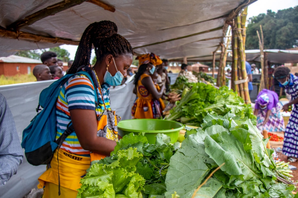 Paciencia, a Congolese refugee farmer manages her stall at an agricultural fair in Lôvua Municipality, Angola.