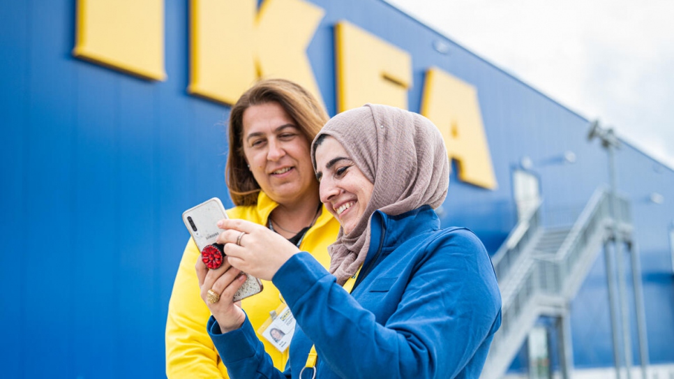 Lajan, 32, talks to her colleague Marija at the IKEA store in Zagreb.