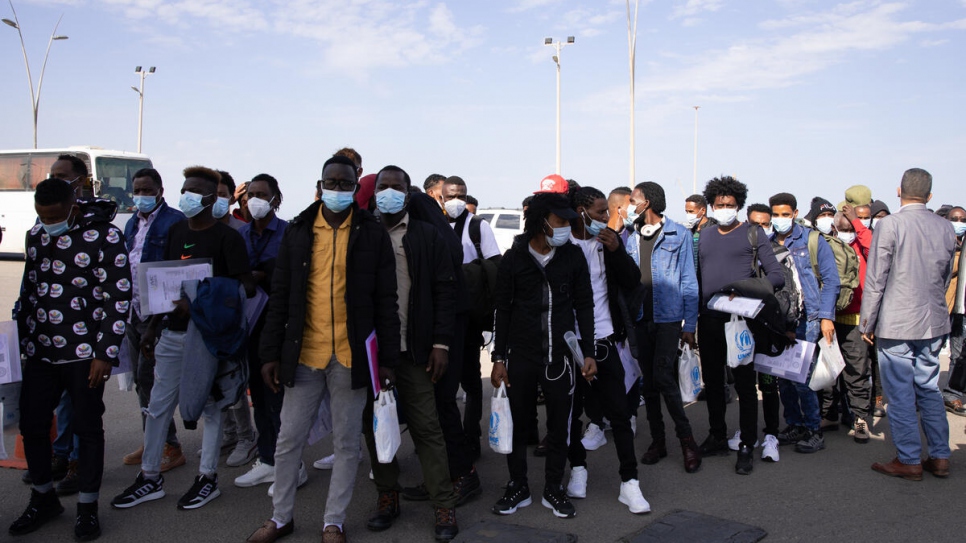 Asylum seekers wait in line to enter Tripoli airport before boarding their flight to Rome.