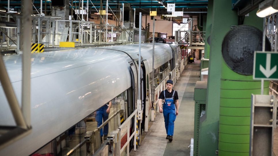 Syrian refugee Mohammad Alkhalaf walks through Deutsche Bahn's Hamburg-Eidelstedt depot, where he is training to be an engineer.