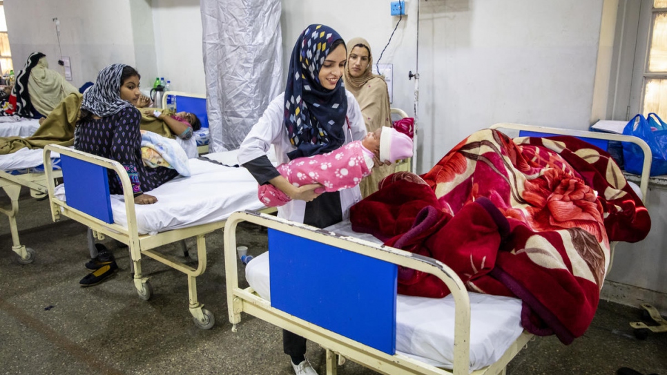 Saleema attends to women and their newborn babies on the postnatal ward at Holy Family Hospital.