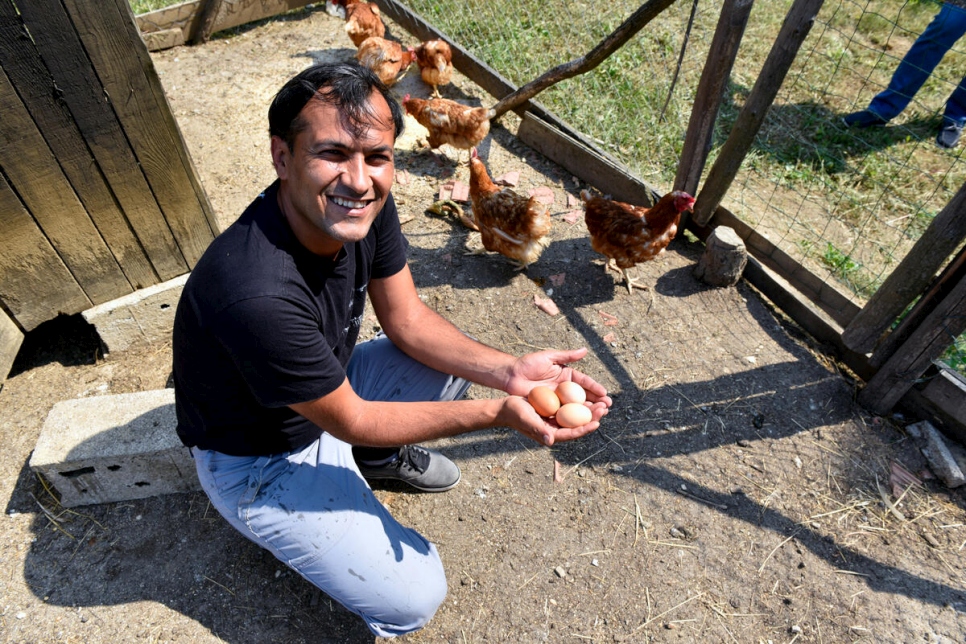 Adel cradles eggs on his farm in northwest Bosnia and Herzegovina. 