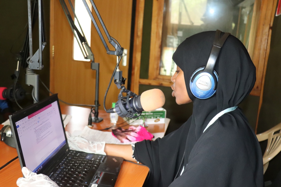 Somali refugee teacher, Amina Hassan, gives an English lesson to grade five pupils over the radio system at Dadaab camp in Kenya. 