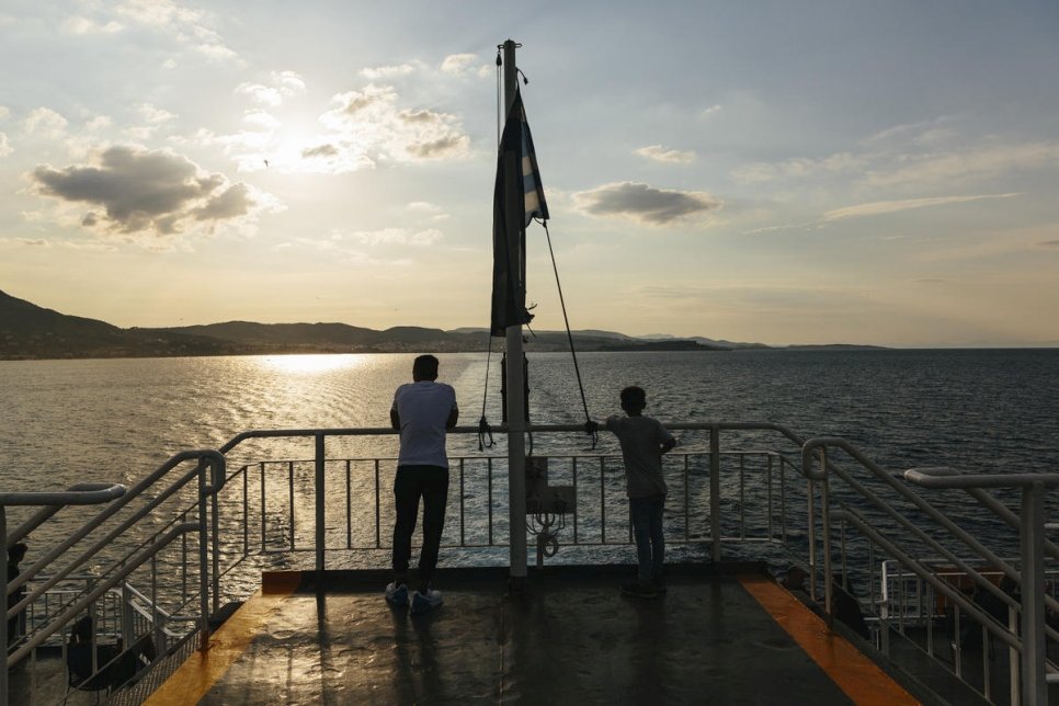 Afghan refugee look across the sea from a ferry departing the port of Mytilene on the island of Lesbos, heading to Piraeus on the mainland.