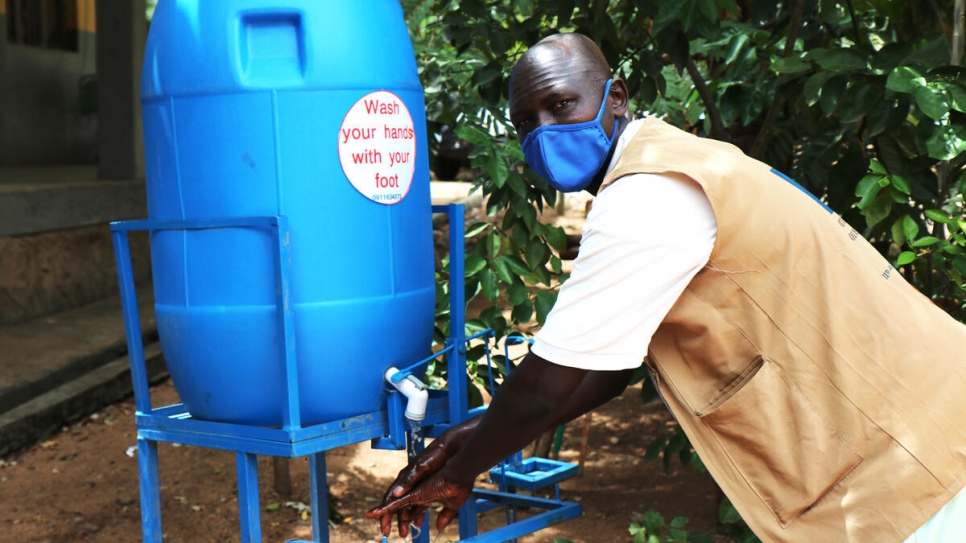 South Sudanese health worker, Tut Kiel Tut, washes his hands at a handwash station outside the health centre in Jewi refugee camp, Ethiopia. 