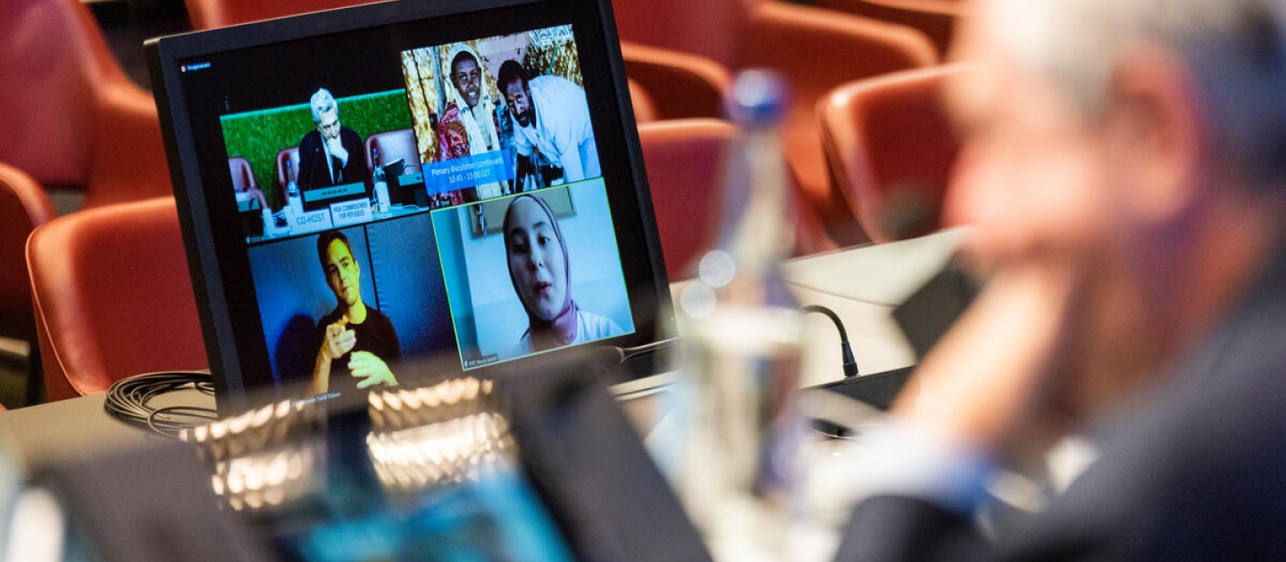 High Commissioner Filippo Grandi listens to a Syrian refugee talk about volunteering during the plenary discussion on the second day of High-Level Officials Meeting taking place virtually in Geneva on 14 and 15 December 2021. The meeting was convened by UNHCR as a follow-up to the 2019 Global Refugee Forum.