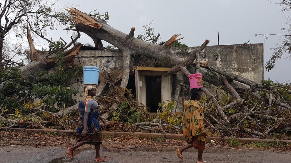 Displaced women walk through a section of Macomia city that was destroyed by Cyclone Kenneth in northern Mozambique.