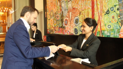 Tajikistan. Afghan refugee Nargis, confidently receiving a guest at the Front Desk, during the Apprenticeship Programme at the renown Sheraton Hotel in Dushanbe