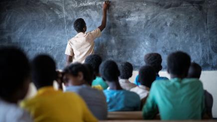 Burkina Faso. A Malian refugee student plays the role of teacher at a school in Goudoubo camp
