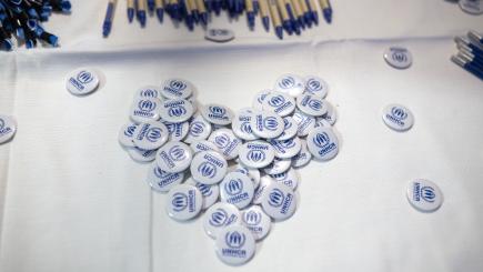 UNHCR badges in a heart shape