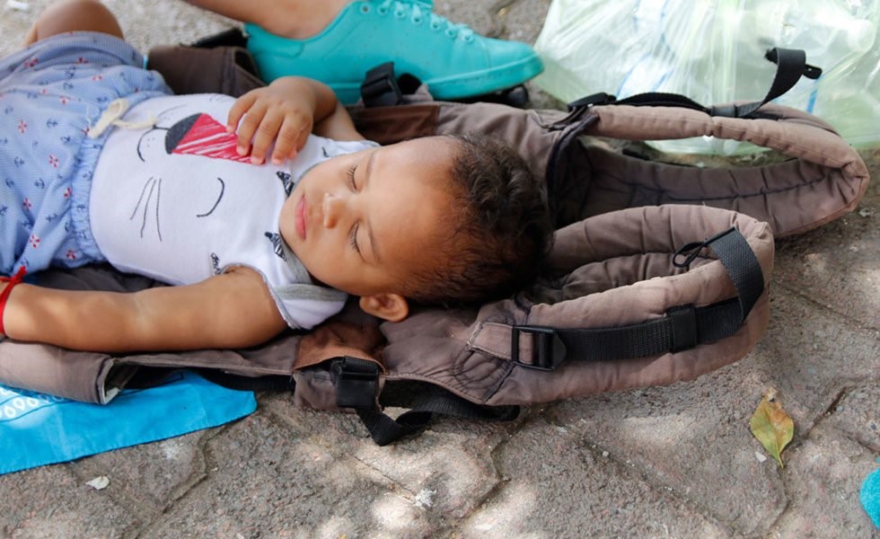 Baby sleeping in the floor.