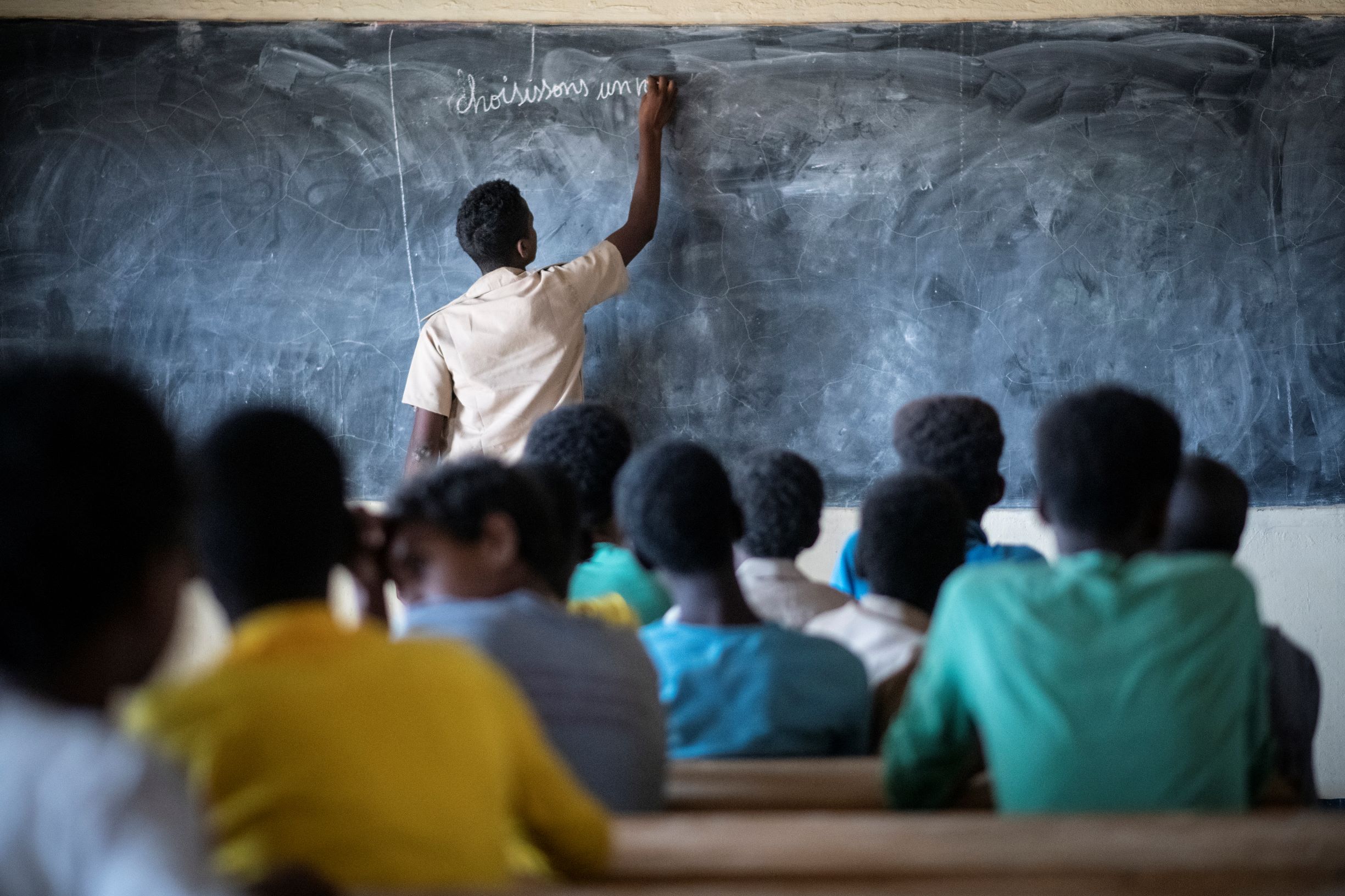 Burkina Faso. A Malian refugee student plays the role of teacher at a school in Goudoubo camp