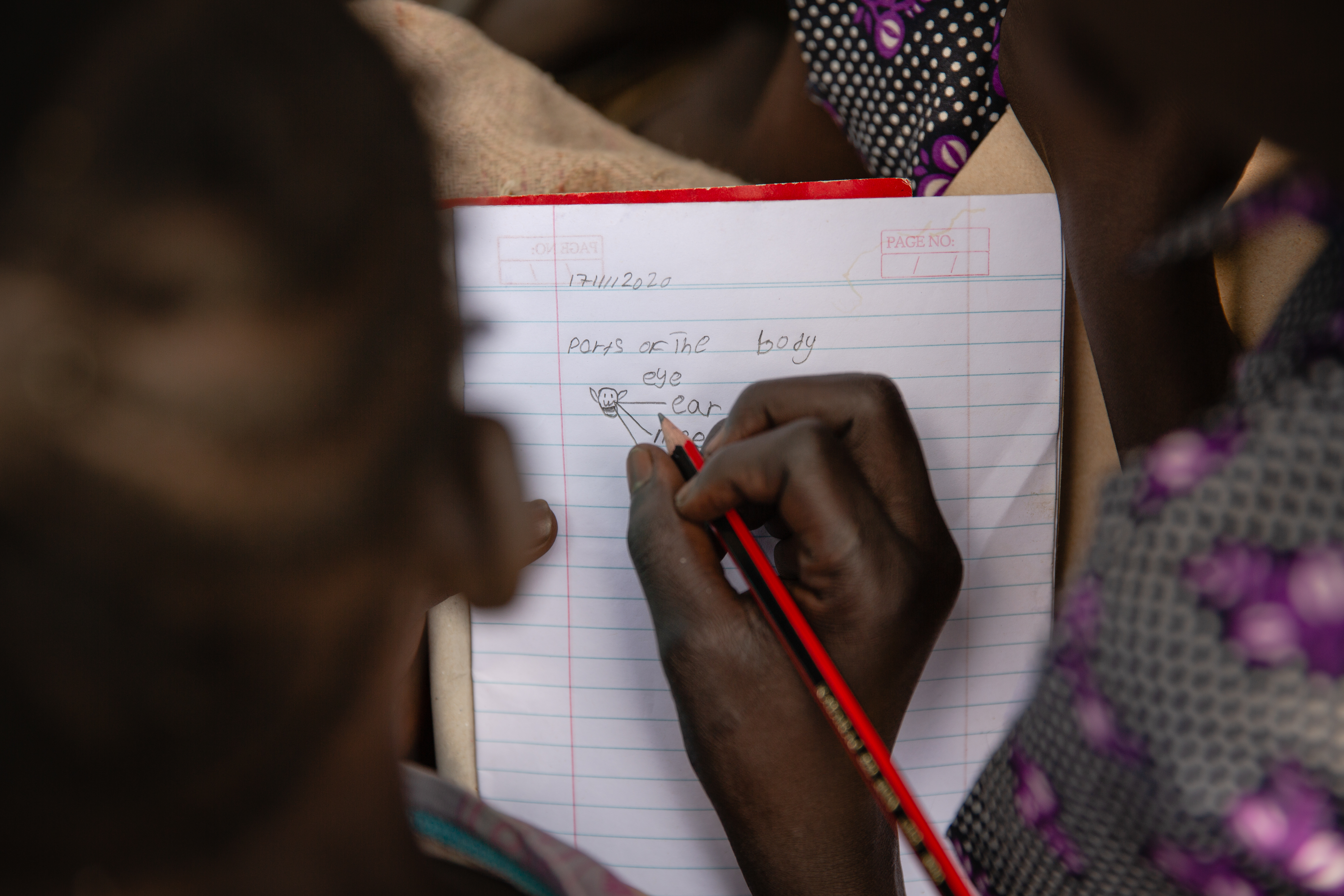 Child writing in notebook 