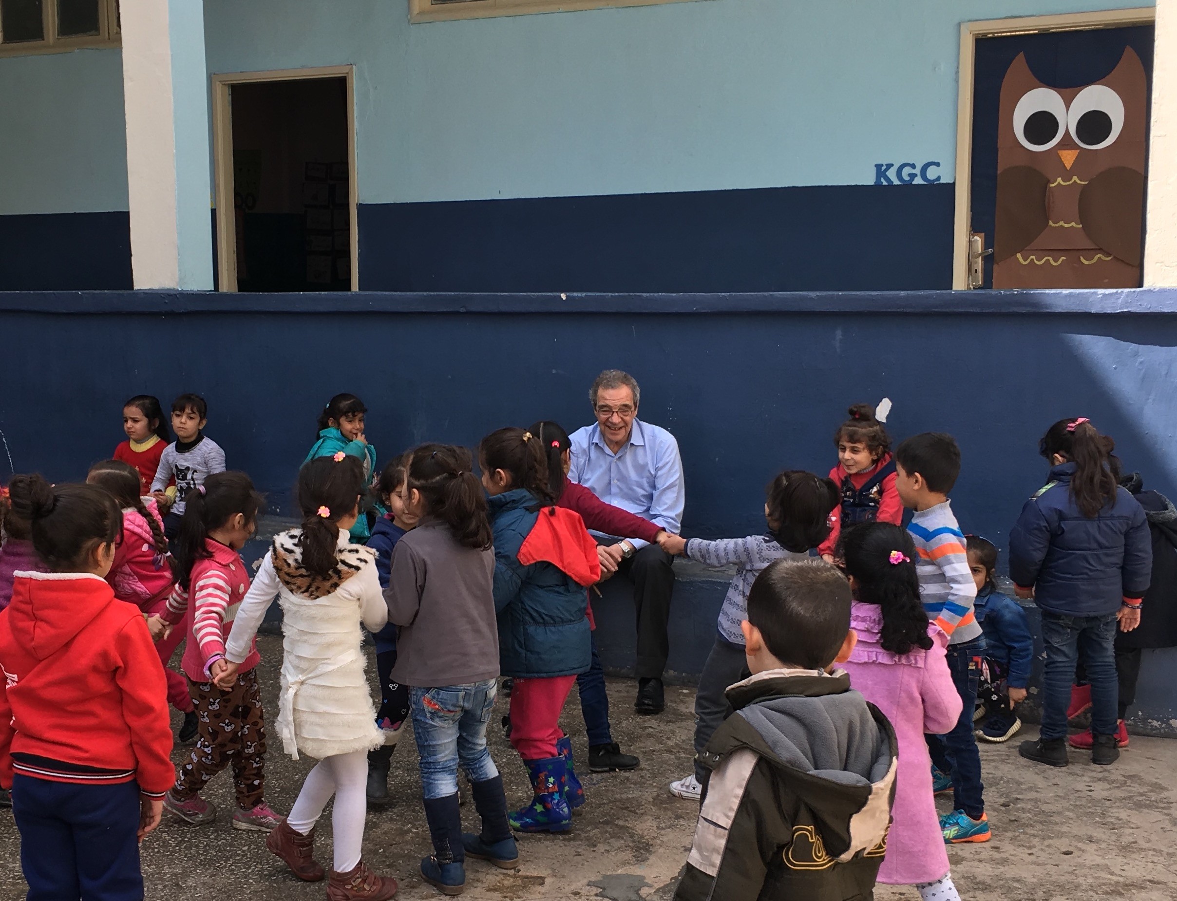 A group of children playing in a playground with a member of the ProFuturo Foundation team