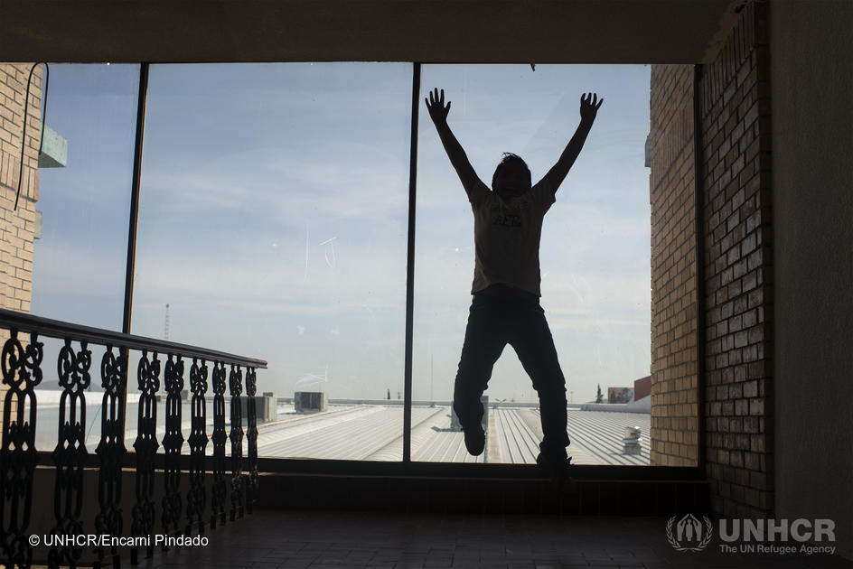 A boy jumps in start of the window