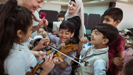 Children testing musicians violin