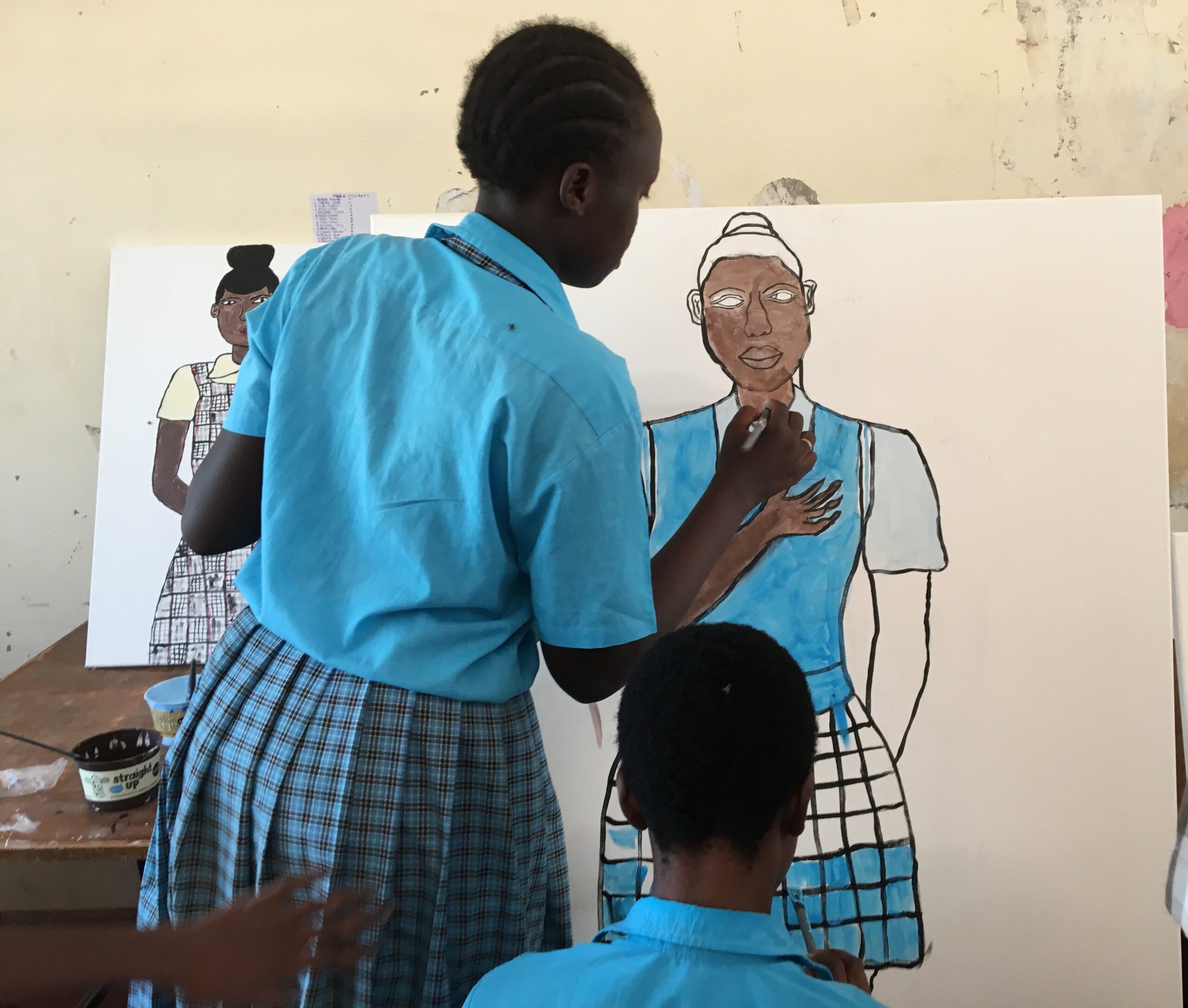 Students taking part in a Hands On Art Workshop paint a portrait