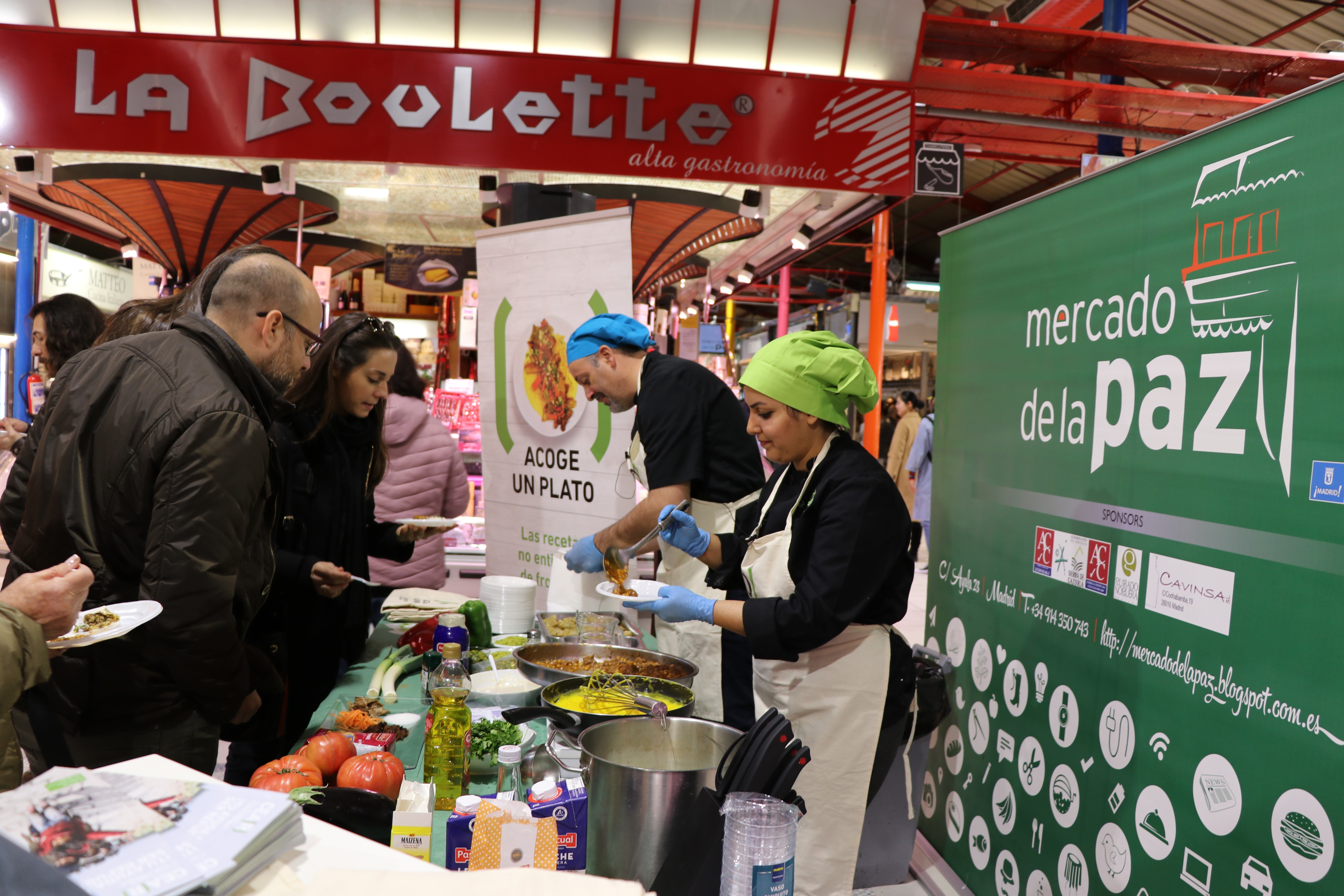 People being served food at a market.