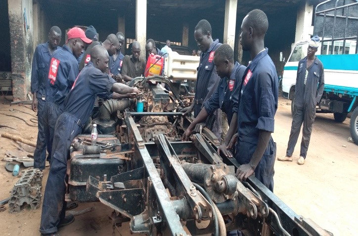 A group of mechanics working on a car
