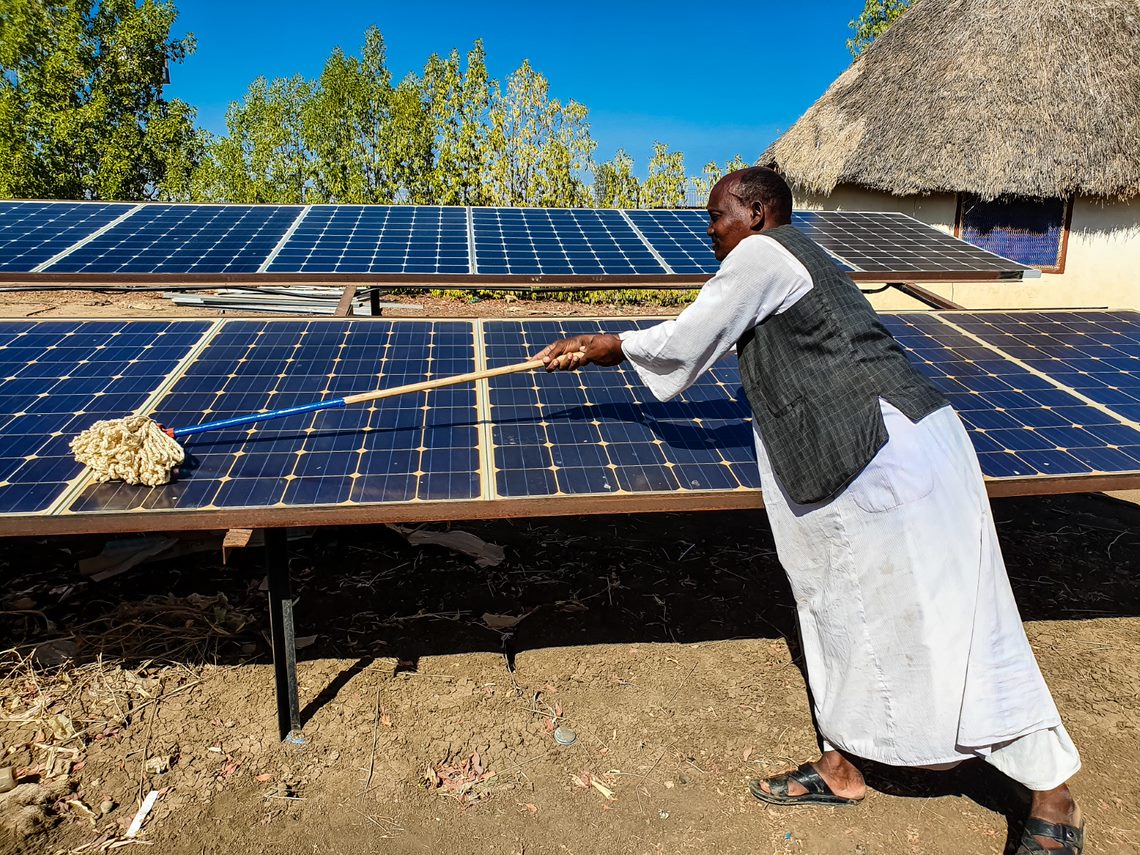 Man cleaning solar panels 