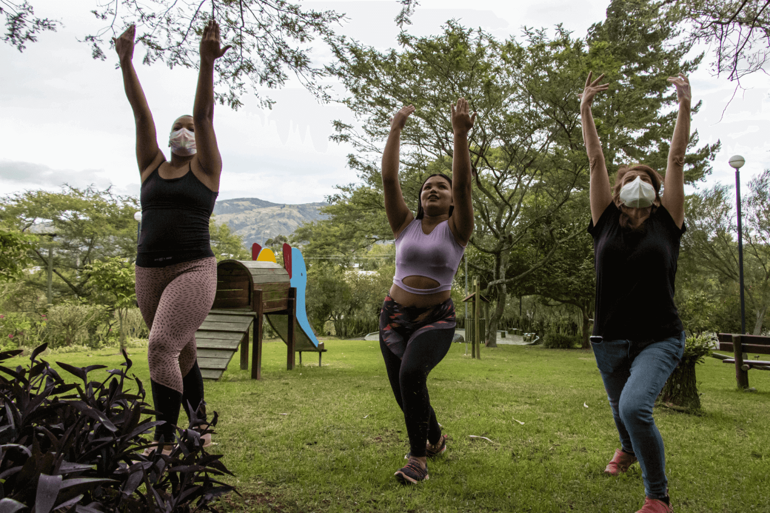 Three refugee women in a garden in Ecuador, telling their stories of teenage pregnancy through contemporary dance