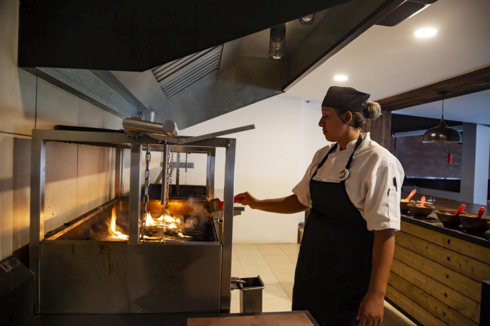 Woman cooking in professional kitchen