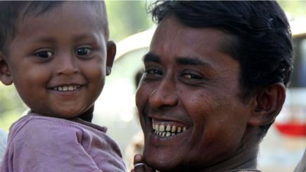 Father and son smiling.