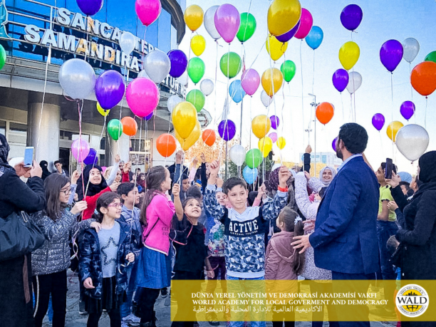 Children holding balloons outdoors.