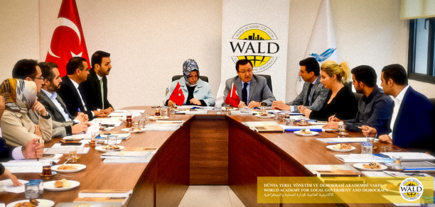 Men and women seated around a conference table.