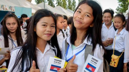 Two student girls attending a career fair face the camera 