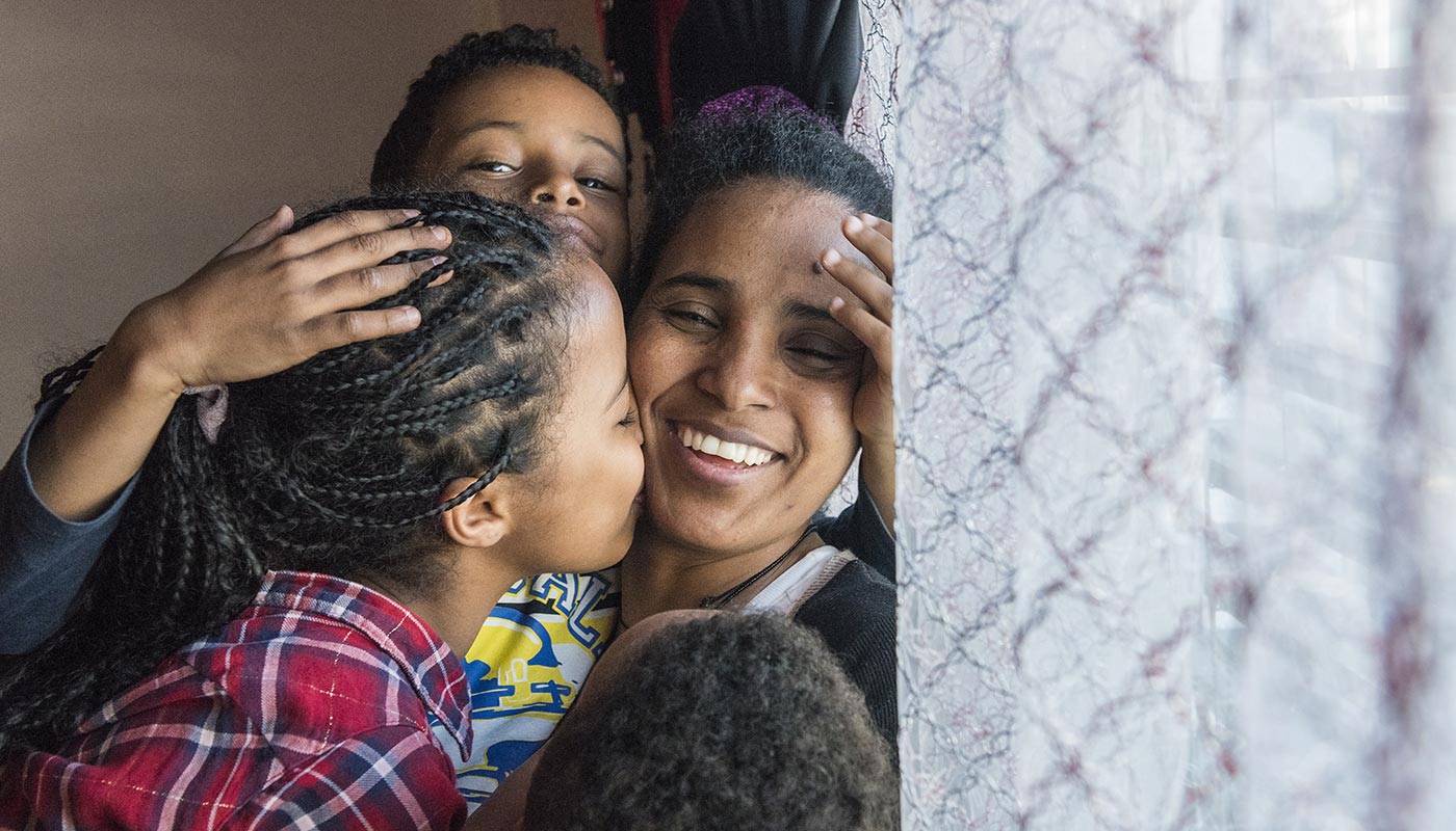 SWITZERLAND. Family reunited after kids who crossed desert were captured in Libya. © UNHCR/Mark Henley