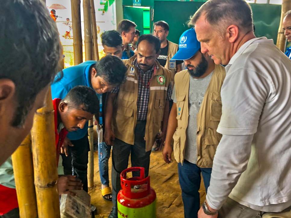 Dr. Ayedh Al-Qahtani, a Senior Representative from the Thani Bin Abdullah Bin Thani Al-Thani Humanitarian Fund is briefed on the Core Relief Items (CRIs) distributed to Rohingya refugees in Cox's Bazar in Bangladesh. 