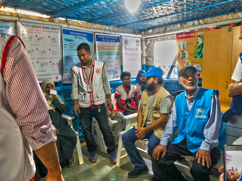 Dr. Ayedh Al-Qahtani, a Senior Representative from the Thani Bin Abdullah Bin Thani Al-Thani Humanitarian Fund is briefed on the Core Relief Items (CRIs) distributed to Rohingya refugees in Cox's Bazar in Bangladesh. 